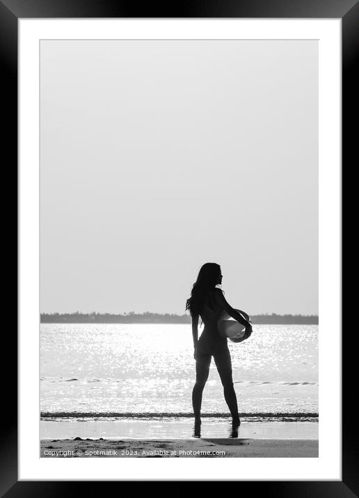Tropical ocean sunrise with girl holding beach ball Framed Mounted Print by Spotmatik 