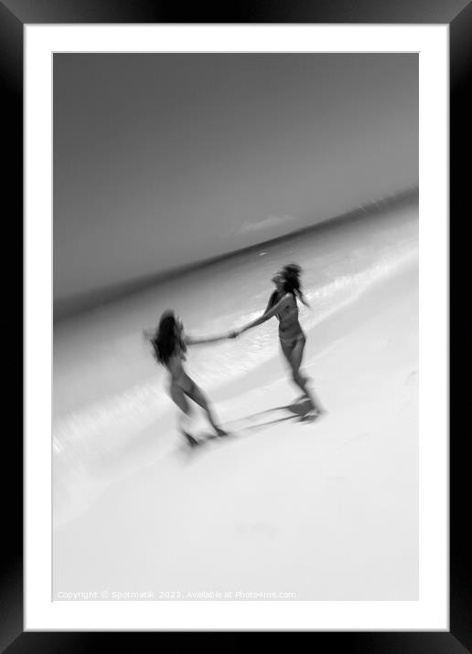 Motion blurred women in swimwear playing by ocean Framed Mounted Print by Spotmatik 