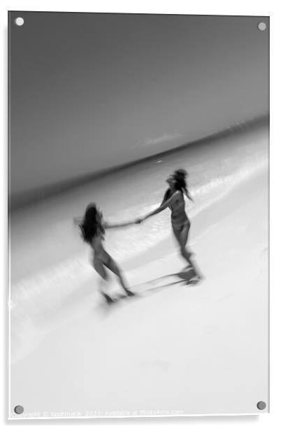 Motion blurred women in swimwear playing by ocean Acrylic by Spotmatik 