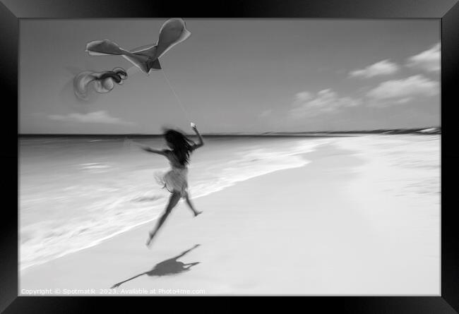 Motion blurred woman jumping on beach flying kite Framed Print by Spotmatik 
