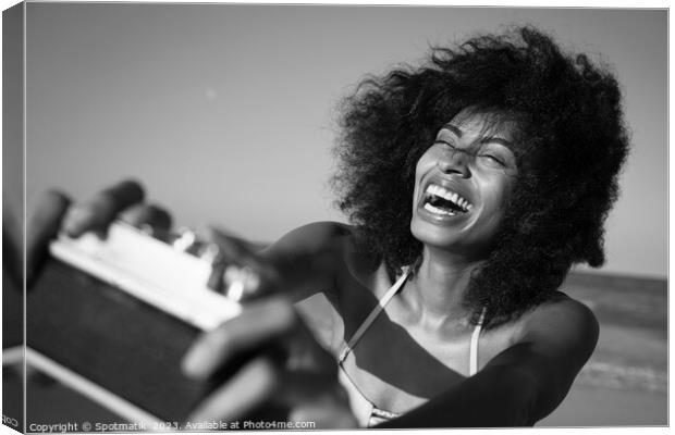 Afro girl laughing at camera taking fun selfie Canvas Print by Spotmatik 
