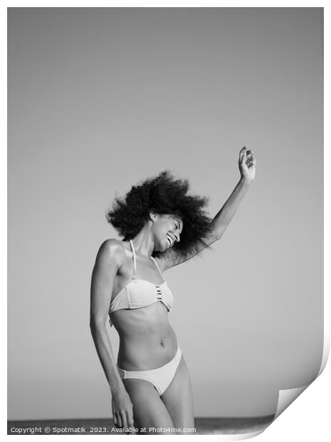 Afro girl in swimwear dancing on the beach Print by Spotmatik 