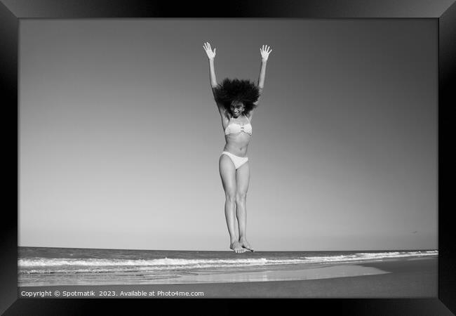 Afro American woman in swimwear jumping for joy Framed Print by Spotmatik 