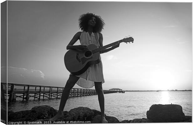 Young African American woman playing guitar at sunrise Canvas Print by Spotmatik 