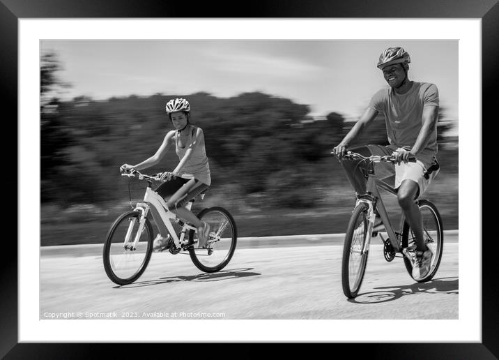 Leisurely cycle ride for young African American couple Framed Mounted Print by Spotmatik 