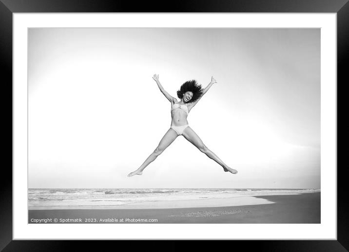 Healthy African American girl jumping high on beach Framed Mounted Print by Spotmatik 