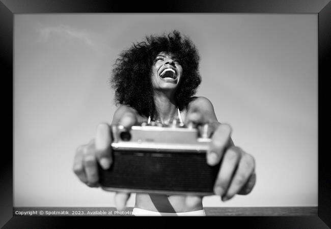 Laughing Afro American girl taking selfie on beach Framed Print by Spotmatik 