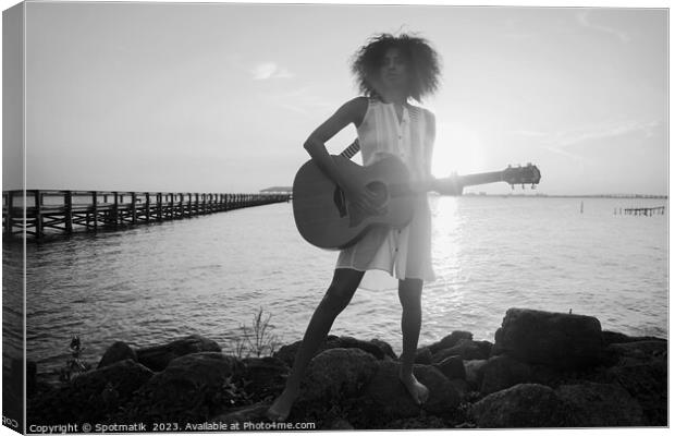 Afro American girl playing guitar with ocean sunset Canvas Print by Spotmatik 