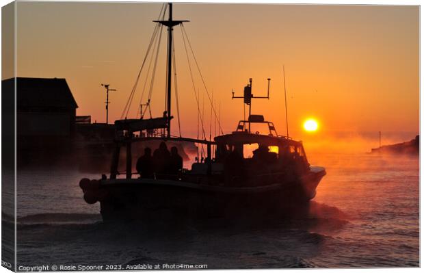 A fishing boat heads out at sunrise Canvas Print by Rosie Spooner