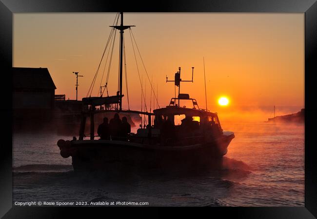A fishing boat heads out at sunrise Framed Print by Rosie Spooner