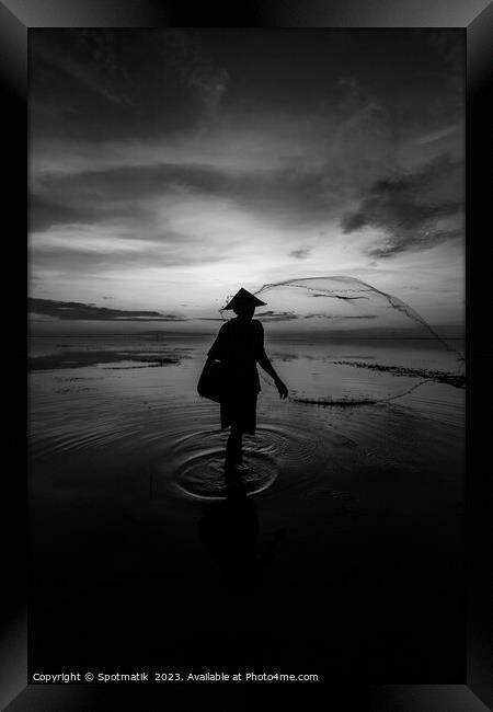 Silhouette Balinese male fishing Indonesian coastline at sunrise Framed Print by Spotmatik 