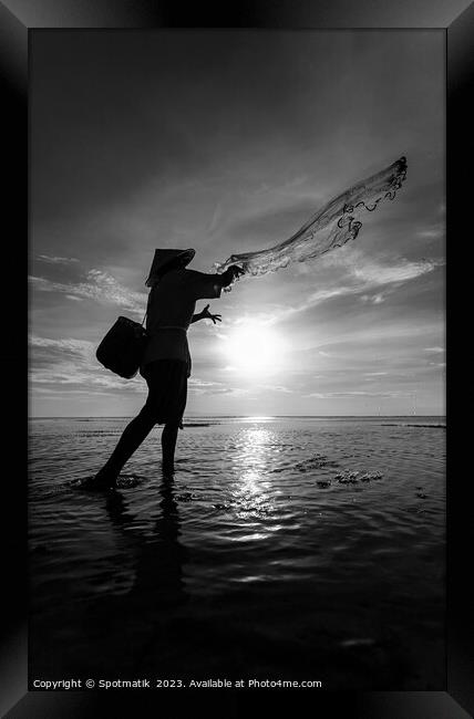 Silhouette Balinese sunrise fisherman casting net Flores sea Framed Print by Spotmatik 