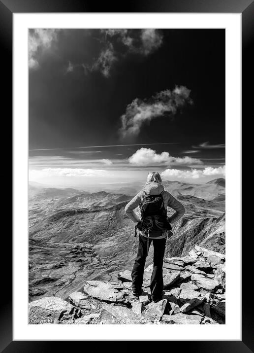 Young female hiker relaxing on mountain summit Wales Framed Mounted Print by Spotmatik 