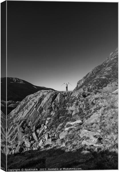 Happy female backpacker on rugged mountain peak Snowdonia Canvas Print by Spotmatik 