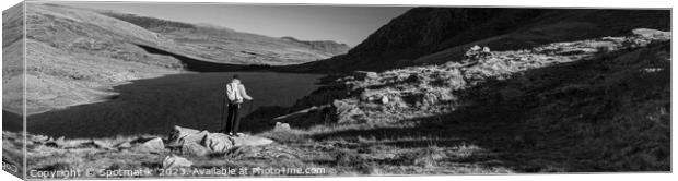 Panoramic lake among mountains with female hiker Snowdonia Canvas Print by Spotmatik 