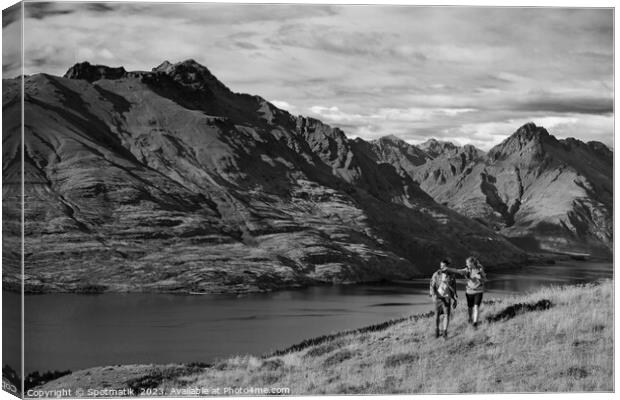 Hikers on trekking expedition enjoying view Lake Wakatipu  Canvas Print by Spotmatik 