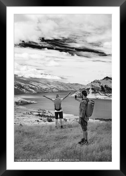 Caucasian male using smartphone taking picture of girlfriend Framed Mounted Print by Spotmatik 