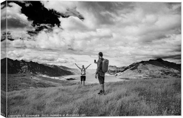 Successful young couple taking smartphone picture Lake Wakatipu  Canvas Print by Spotmatik 