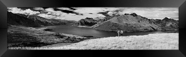 Panorama of New Zealand trekking couple viewing Lake Wakatipu Framed Print by Spotmatik 