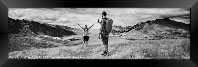 Panorama of young backpacking couple taking smartphone picture Framed Print by Spotmatik 