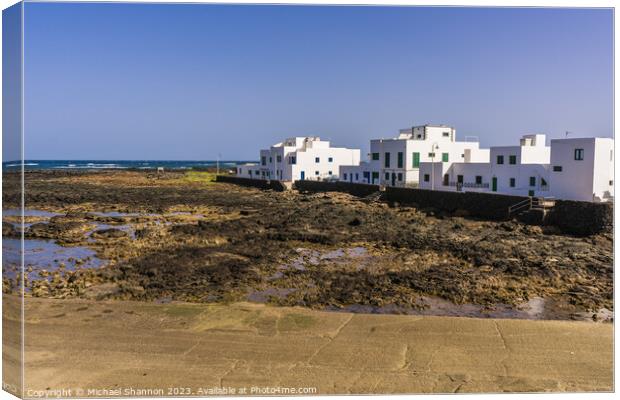 Beachfront houses, Orzola, Northern Lanzarote. Canvas Print by Michael Shannon