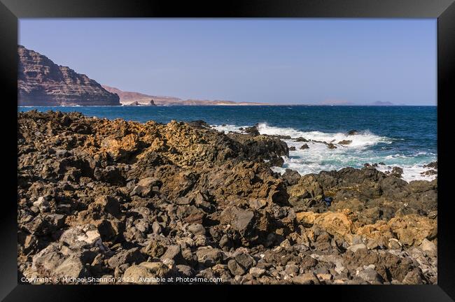 The wild rocky coastline near Orzola in Northern L Framed Print by Michael Shannon