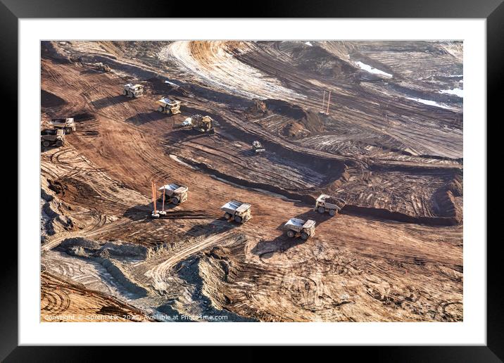 Aerial view giant dump trucks carrying mined Oilsand  Framed Mounted Print by Spotmatik 