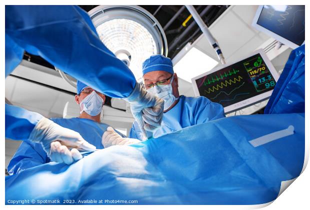 Caucasian surgical team wearing scrub operating on patient Print by Spotmatik 