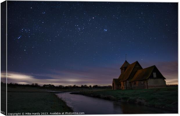 Starlit church by frozen dyke. Canvas Print by Mike Hardy