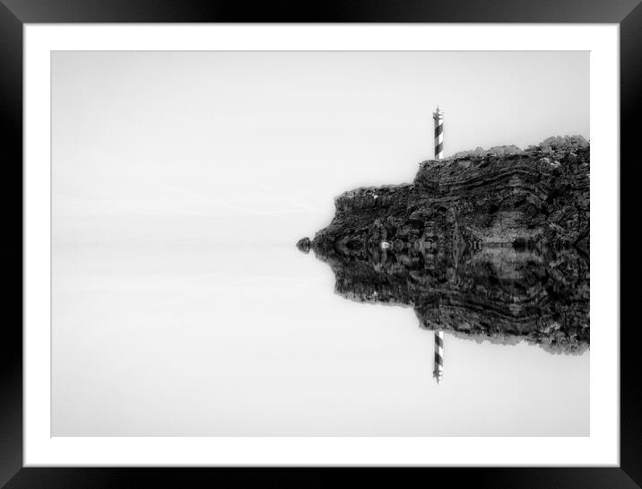 Photography with the reflection of the lighthouse next to the cliff in the sea in black and white Framed Mounted Print by Vicen Photo