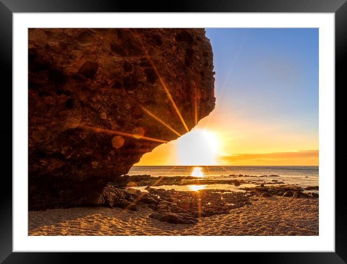 Photography with the sunrise sun behind the rock of the beach of the dead Framed Mounted Print by Vicen Photo