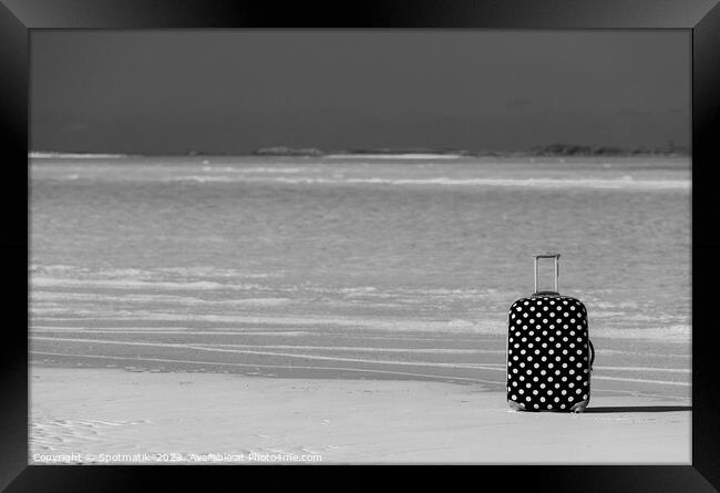 Red polka dot travel suitcase on sand beach Framed Print by Spotmatik 