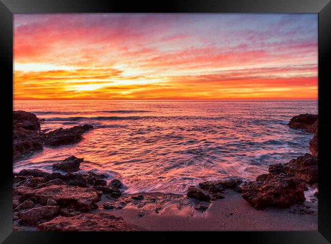 Photograph with a reddish sunrise in a small cove of la renega in Oropesa Framed Print by Vicen Photo