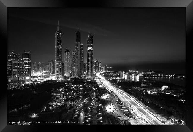 Dubai dusk illuminated view Sheikh Zayed city skyscrapers  Framed Print by Spotmatik 