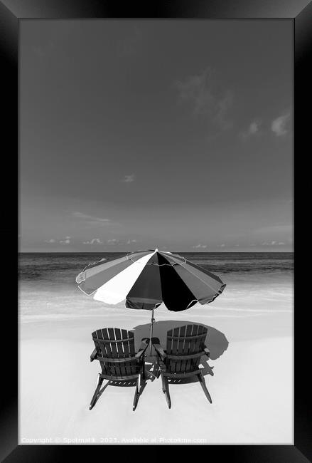 Bahamas beach umbrella and chairs on sandy beach  Framed Print by Spotmatik 