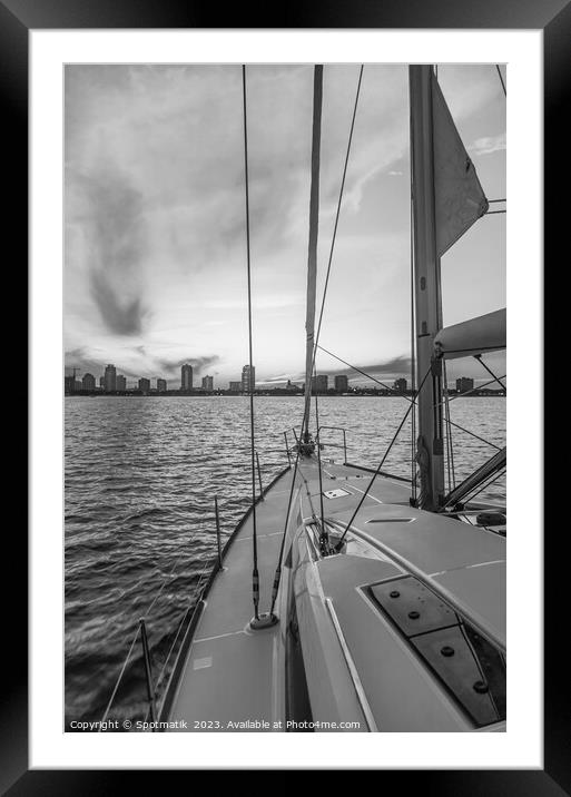 Sailing luxury yacht at sunset with cityscape view Framed Mounted Print by Spotmatik 