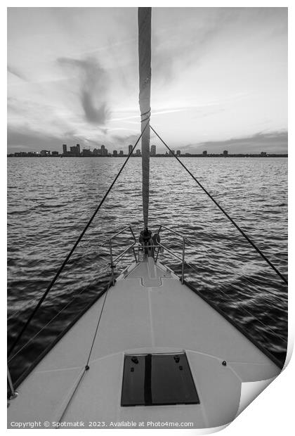 Bow of yacht sailing towards cityscape at sunrise Print by Spotmatik 