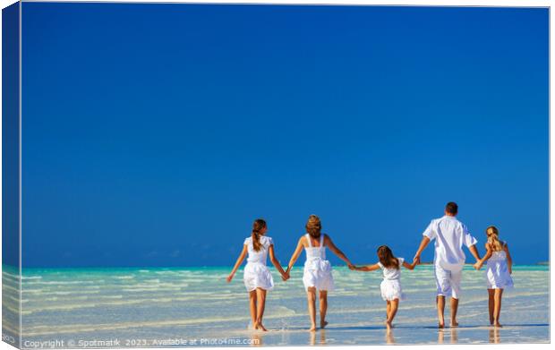 Happy Caucasian family on tropical beach enjoying leisure Canvas Print by Spotmatik 