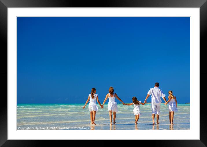 Happy Caucasian family on tropical beach enjoying leisure Framed Mounted Print by Spotmatik 