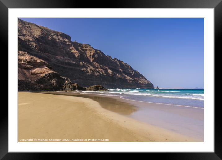 The beach at Orzola near the cliffs of the Punta F Framed Mounted Print by Michael Shannon