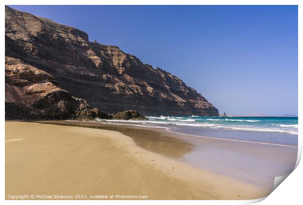 The beach at Orzola near the cliffs of the Punta F Print by Michael Shannon