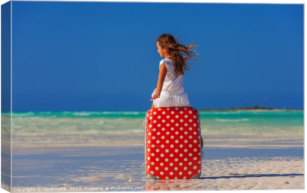 Girl sitting on red polka dot travel suitcase  Canvas Print by Spotmatik 