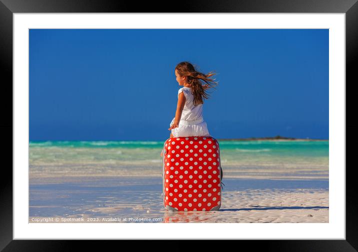 Girl sitting on red polka dot travel suitcase  Framed Mounted Print by Spotmatik 