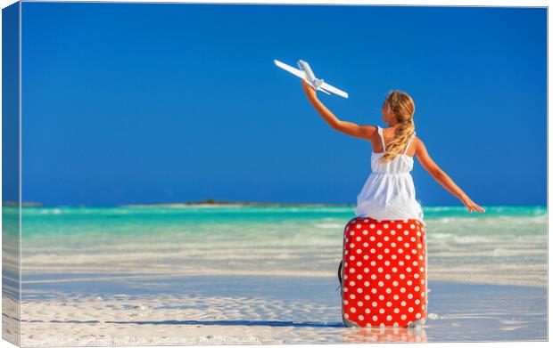 Girl sitting on red travel luggage on beach plane Canvas Print by Spotmatik 