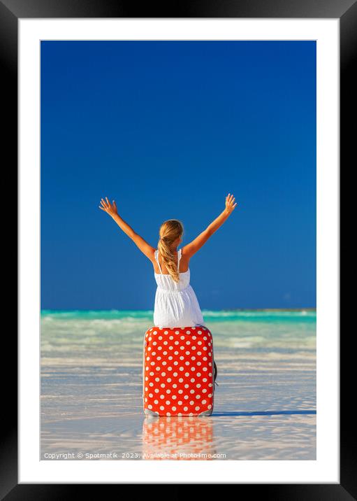 Blonde female teenager on beach sitting on suitcase Framed Mounted Print by Spotmatik 