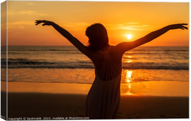 Carefree Bohemian girl dancing on beach at sunset Canvas Print by Spotmatik 