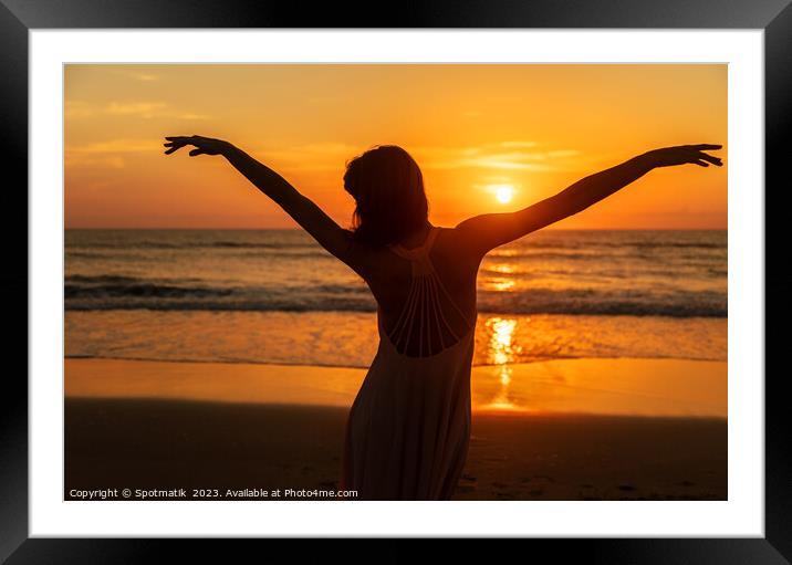 Carefree Bohemian girl dancing on beach at sunset Framed Mounted Print by Spotmatik 