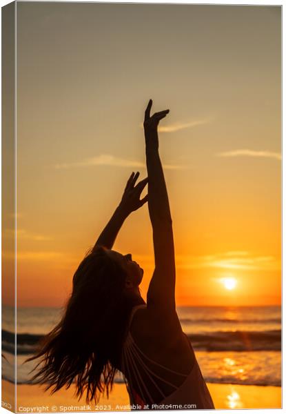 Bohemian girl enjoying carefree lifestyle dancing on beach Canvas Print by Spotmatik 