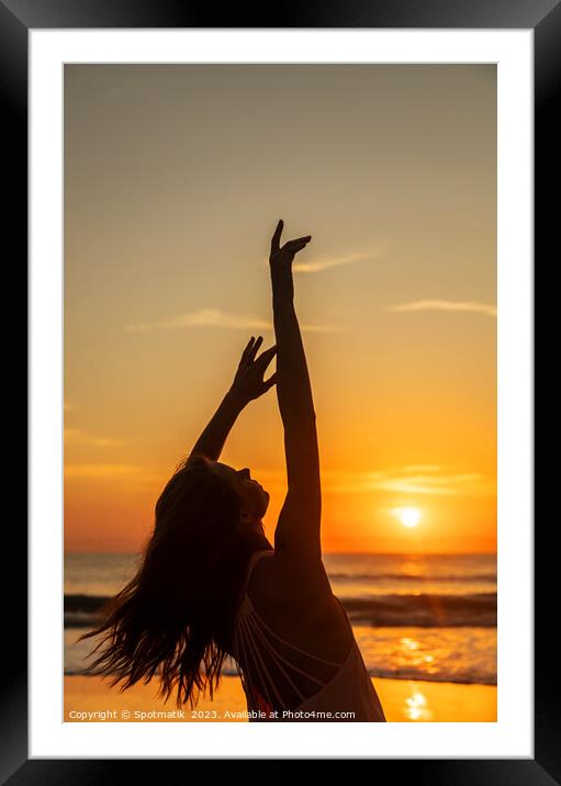 Bohemian girl enjoying carefree lifestyle dancing on beach Framed Mounted Print by Spotmatik 