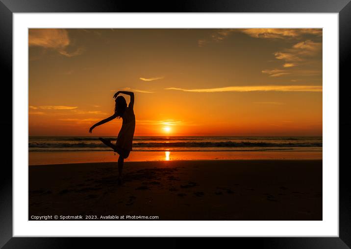 Happy young girl dancing on beach at sunset Framed Mounted Print by Spotmatik 